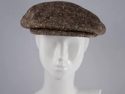 Brown wool tweed flat cap with gold lining.