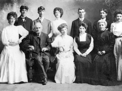 My husband’s grandfather, John, with his wife Ellen and their nine children (1911).