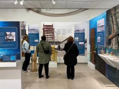 Three museum guests view the Bluewaterland exhibit.