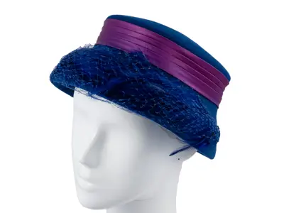 Hazel Matthews: Lampshade-shaped royal blue felt hat with blue feathers and a purple satin ribbon.