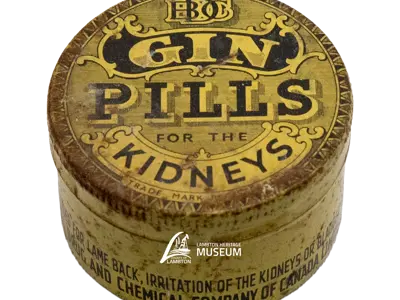 Cylindrical metal pill container. It contained Gin Pills made by the National Drug and Chemical Company of Canada between 1920 and 1940.