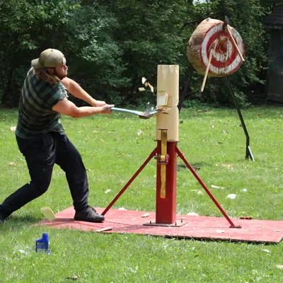 A lumberjack swings his axe at a pole.