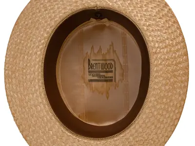 Label on boater hat reading "Brentwood Stylish Summer Headwear."