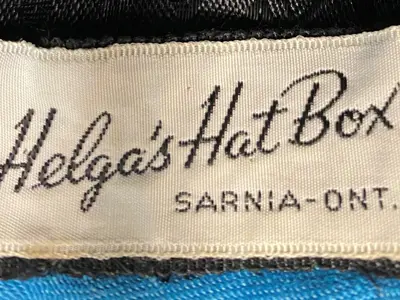 13.	This hat bears the label of Helga’s Hat Box, a shop owned by Helga (Groebel) Telzer on N. Brock Street in Sarnia in the 1950s and 1960s. 