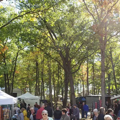 People walking around tents outdoors
