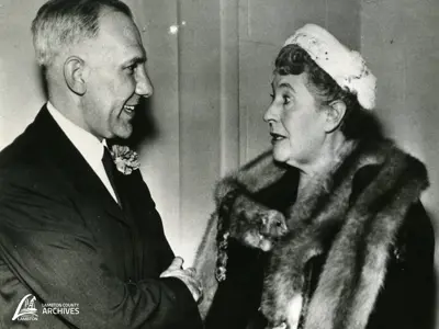 Alderman Ruth Donohue dressed smartly in a fur stole and pillbox hat in animated discussion with leader of the Ontario Liberal Party, John Wintermeyer, c. 1950s-60s. 