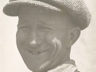 Unknown man wearing a flat cap.