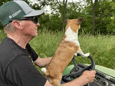 Rob Annett and his dog driving back after repairing a fence on the Annett family farm in 2025.